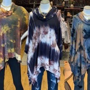 Lace up the back poncho. Middle item in navy.